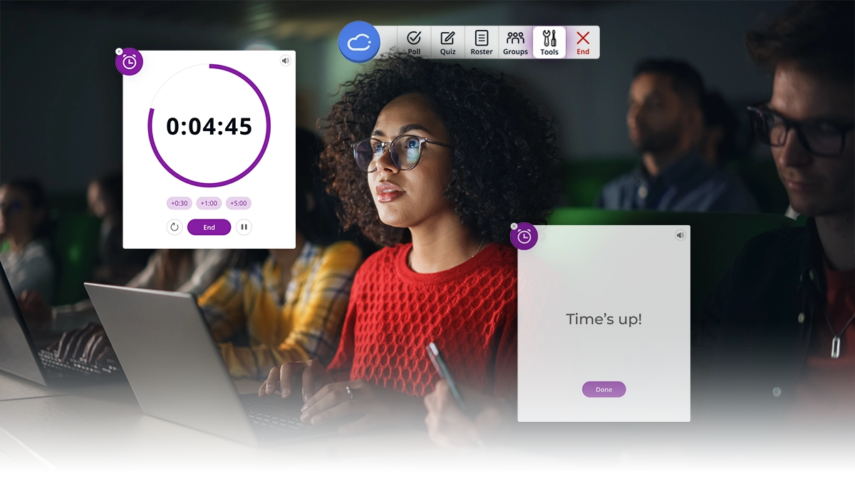 A young woman in glasses and a red sweater looks up from her laptop to check the time. Stock photo credit: Gorodenkoff/Shutterstock